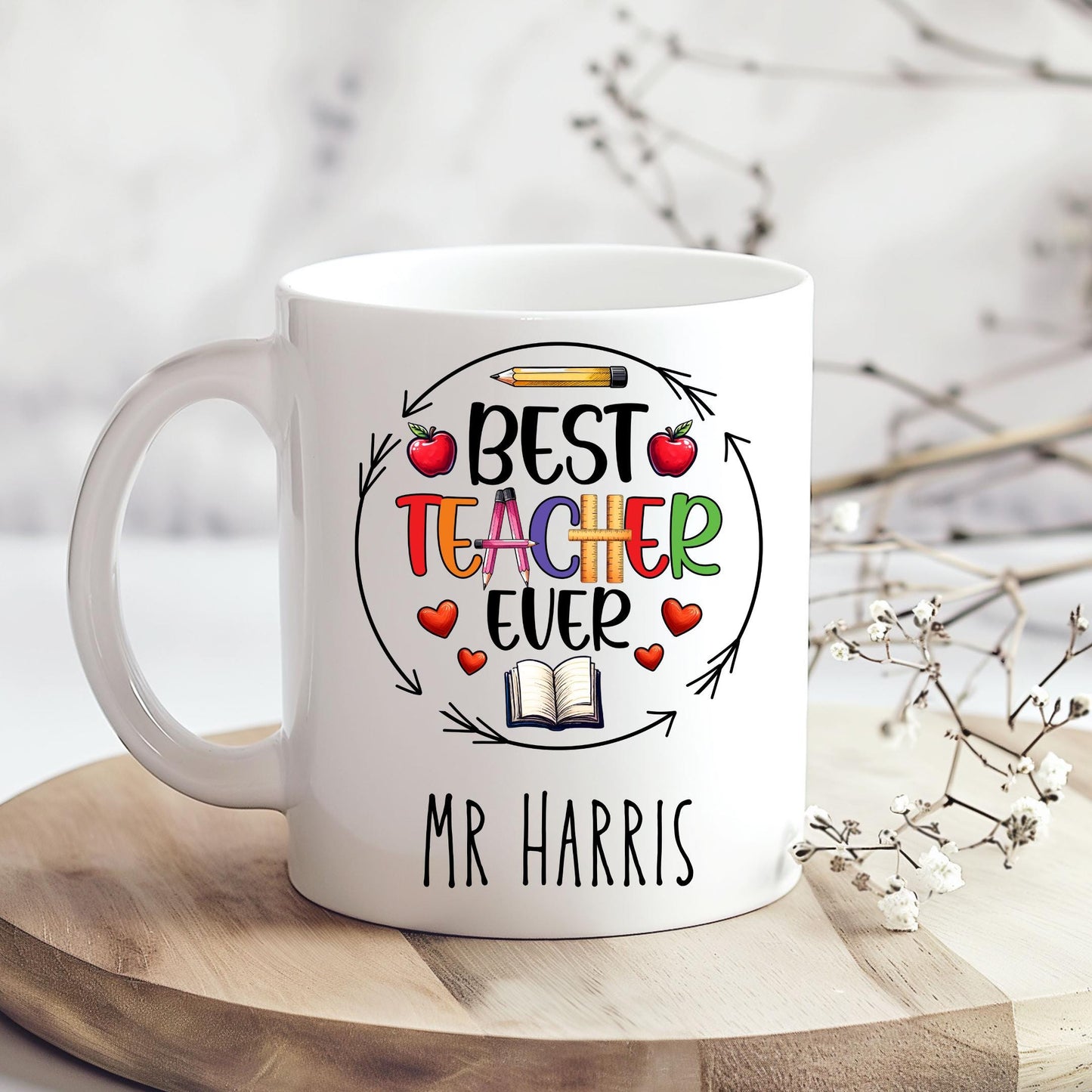 Fun and cheerful mug with the words βBest Teacher Everβ in bright, bold letters, surrounded by cute doodles of a books, shiny red apples, and a smiling yellow pencil. Teachers Gift. Under Β£10.
