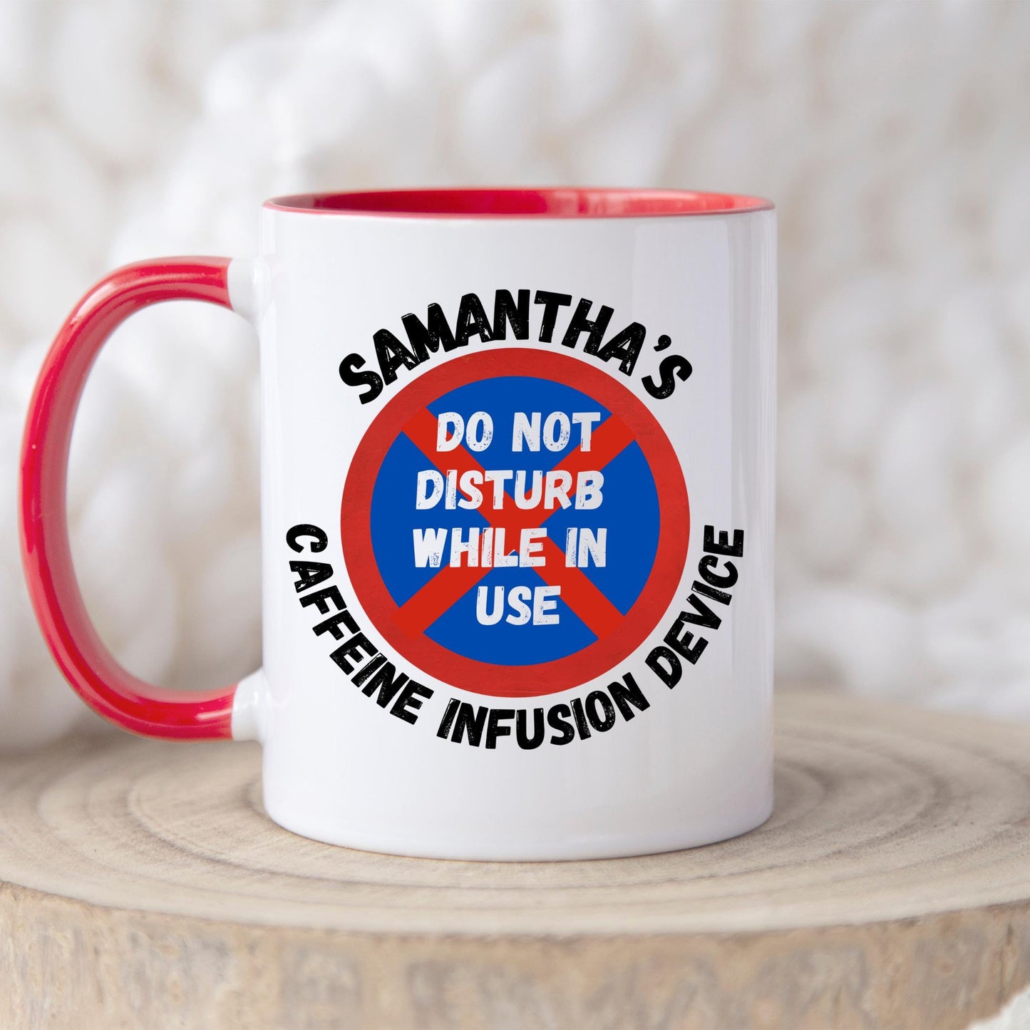 White ceramic coffee mug with coloured or Plain handle, on a wooden tray with black text that reads 'Samantha's Caffeine Infusion Device' surrounding a red and blue sign that says 'Do Not Disturb While in Use.' The perfect gift for a coffee lover