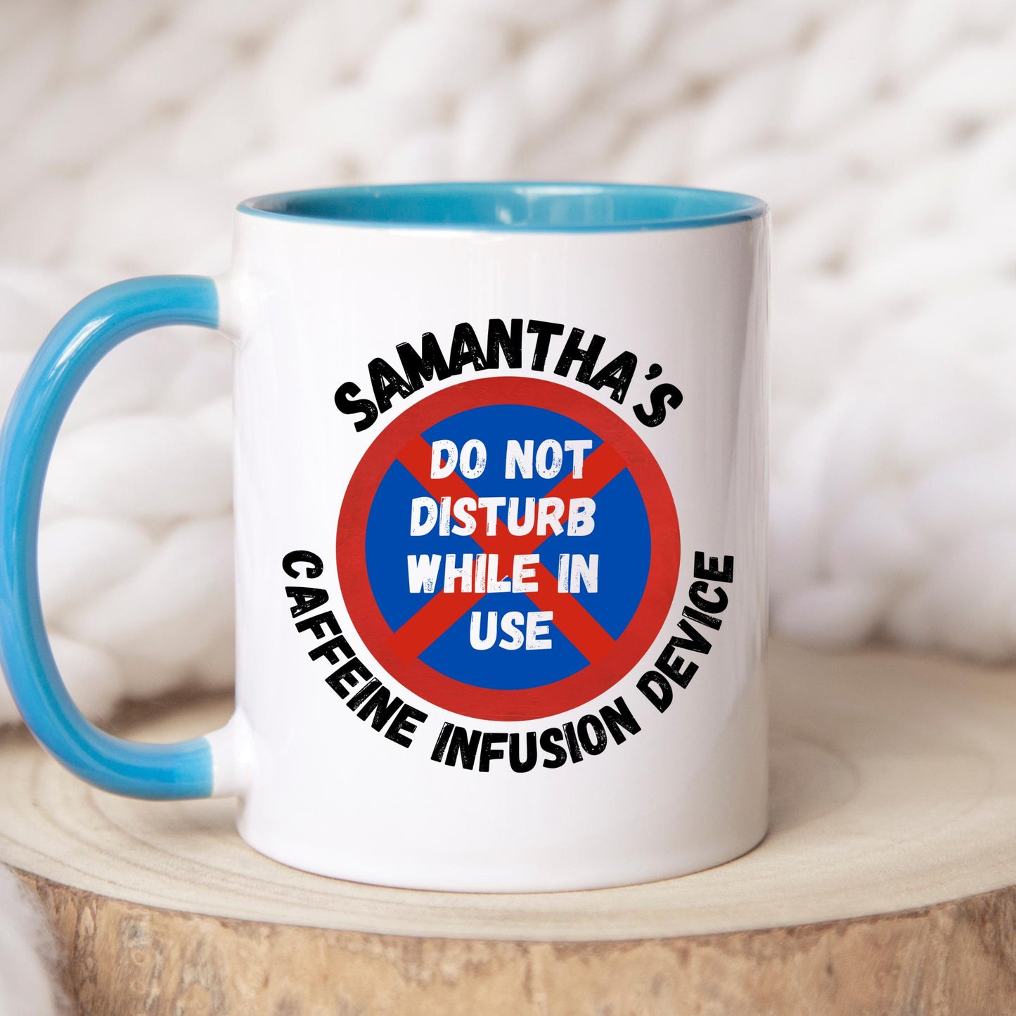 White ceramic coffee mug with coloured or Plain handle, on a wooden tray with black text that reads 'Samantha's Caffeine Infusion Device' surrounding a red and blue sign that says 'Do Not Disturb While in Use.' The perfect gift for a coffee lover