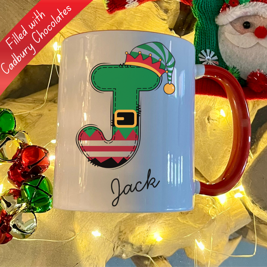 Personalised Red Elf letter christmas mug filled with Cadbury Chocolates