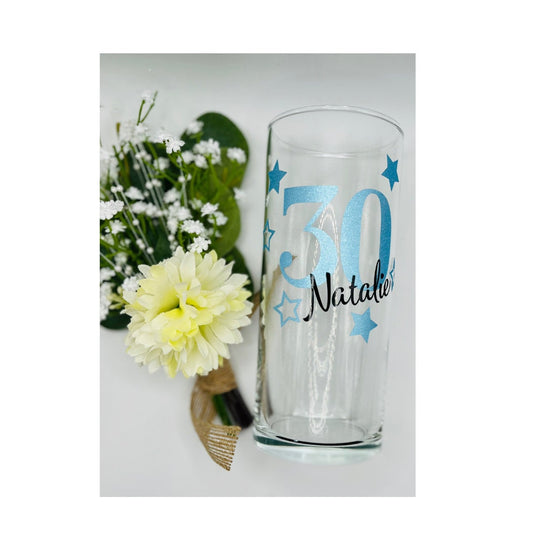 Personalised glass with decorative star design — custom name and age gift. Available in gold, silver, rose gold and more. Choice of gin glass, wine glass, shot glass or matching lit wine bottle. Unique keepsake for birthdays, celebrations or special occasions. Gift-wrapped with optional personalised tote bag.
