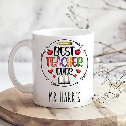 Fun and cheerful mug with the words “Best Teacher Ever” in bright, bold letters, surrounded by cute doodles of a books, shiny red apples, and a smiling yellow pencil. Teachers Gift. Under £10.