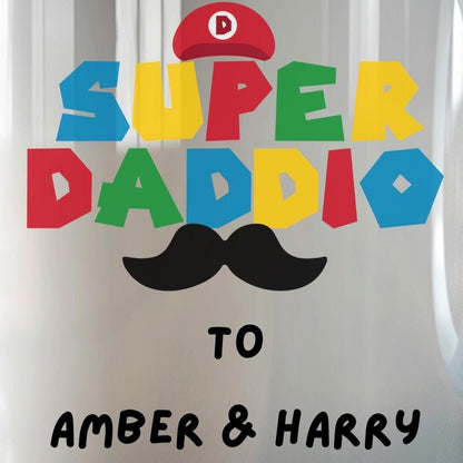 White ceramic coffee mug with colorful text reading &#39;Super Daddio&#39;, a red Mario-style hat, black moustache graphic, and personalised &#39;To Amber & Harry&#39; message – perfect custom Father&#39;s Day gift for gamer dads.