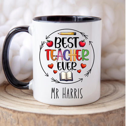 Fun and cheerful mug with the words “Best Teacher Ever” in bright, bold letters, surrounded by cute doodles of a books, shiny red apples, and a smiling yellow pencil. Teachers Gift. Under £10.